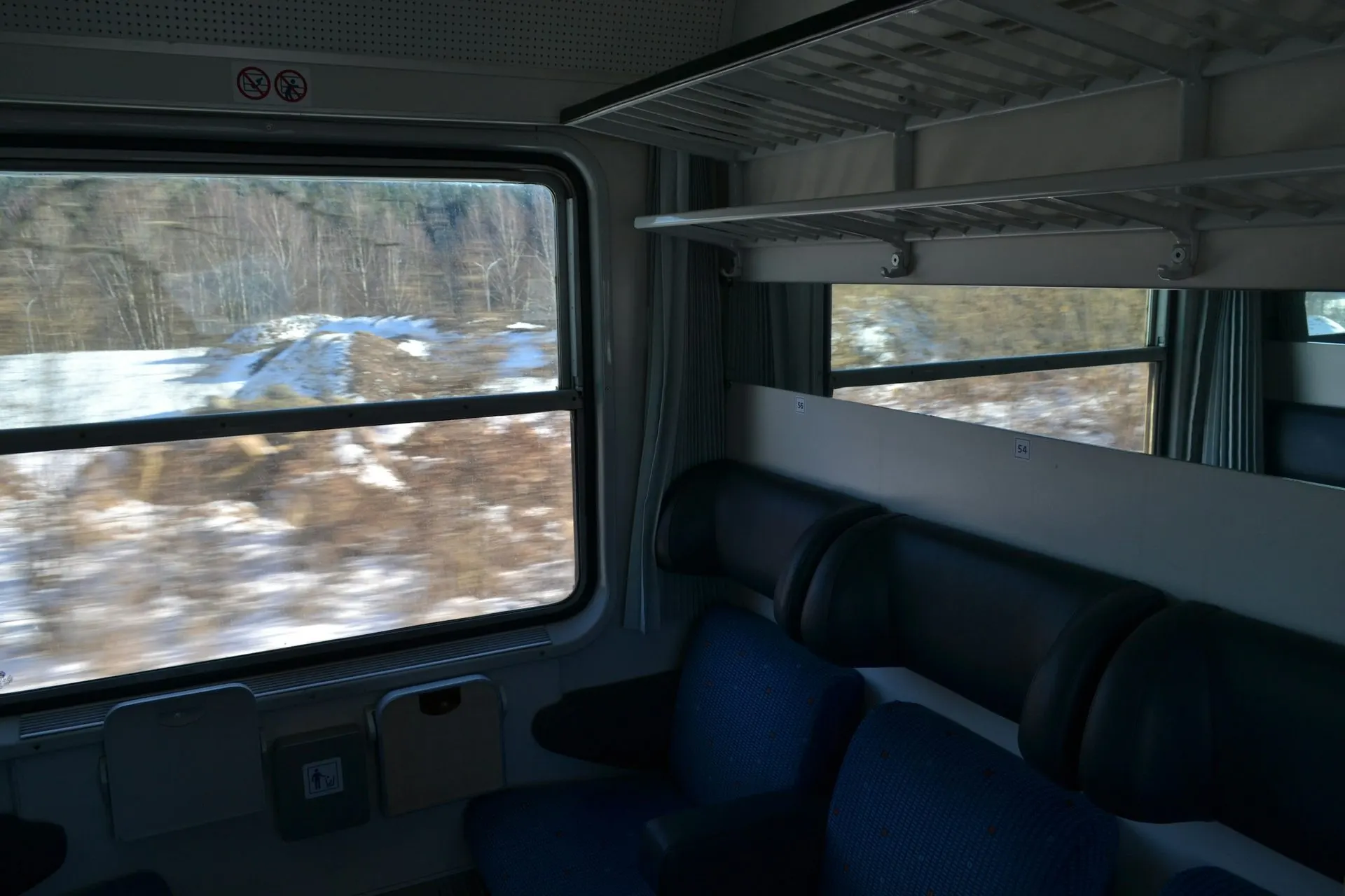 Train compartment window with passing European scenery
