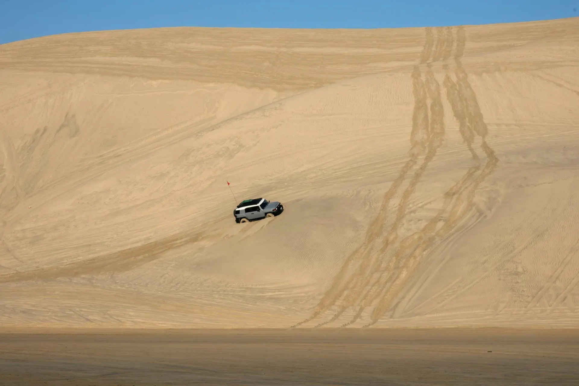 SUV dune bashing on a huge sand dune